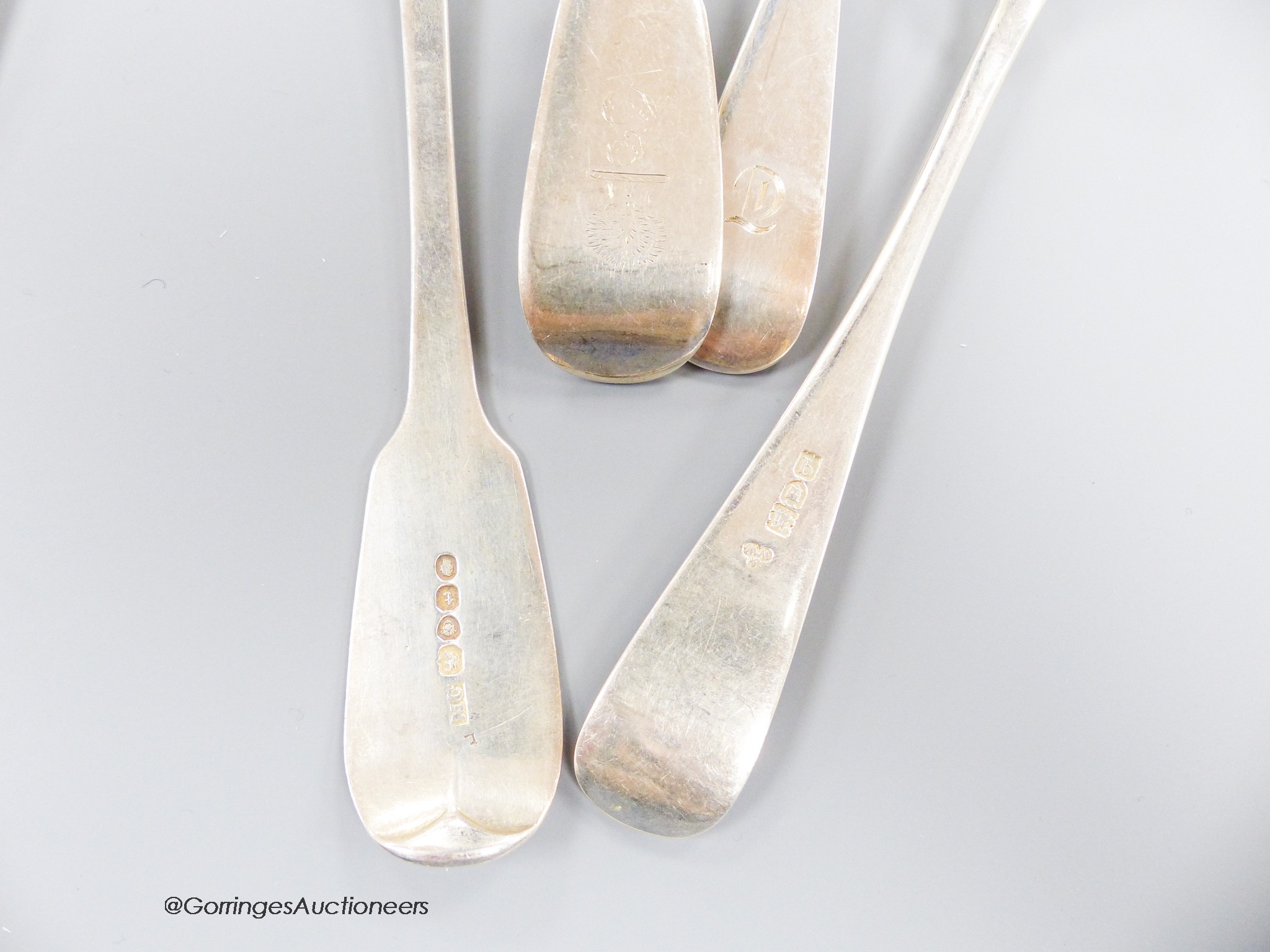 A part canteen of George V silver Hanovarian pattern flatware, comprising nineteen items, Wakely & Wheeler, London, 1911 and two earlier silver fiddle pattern tablespoons, 41.5oz.